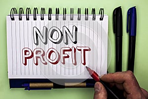 Writing note showing Non Profit. Business photo showcasing Charitable Wrothless Philanthropy Aid Unlucrative Profitless written b