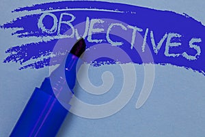 Writing note showing Objectives. Business photo showcasing Goals planned to be achieved Desired targets Company missions Bold blue