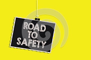 Writing note showing Road To Safety. Business photo showcasing Secure travel protect yourself and others Warning Caution Hanging b
