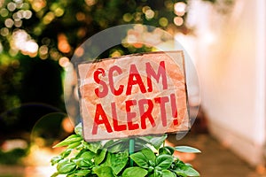 Writing note showing Scam Alert. Business photo showcasing fraudulently obtain money from victim by persuading him Plain