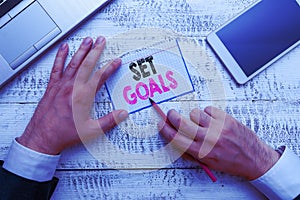 Writing note showing Set Goals. Business photo showcasing Defining or achieving something in the future based on plan.