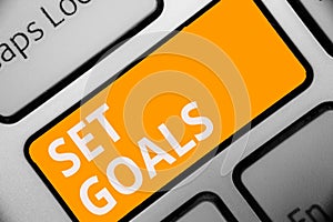 Writing note showing Set Goals. Business photo showcasing Defining or achieving something in the future based on plan Keyboard ora