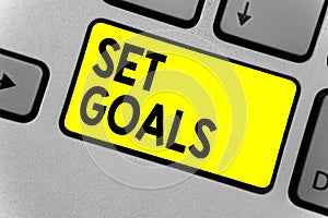 Writing note showing Set Goals. Business photo showcasing Defining or achieving something in the future based on plan Keyboard yel