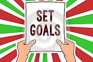 Writing note showing Set Goals. Business photo showcasing Defining or achieving something in the future based on plan Man holding