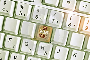 Writing note showing Set Smart Goals. Business photo showcasing giving criteria to guide in the setting of objectives White pc