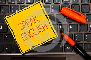 Writing note showing Speak English. Business photo showcasing Study another Foreign Language Online Verbal Courses Yellow paper ke