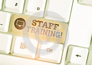 Writing note showing Staff Training. Business photo showcasing program that helps employees learn specific knowledge White pc