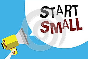 Writing note showing Start Small. Business photo showcasing Small medium enterprises start up Business entrepreneurship Man holdin