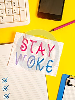 Writing note showing Stay Woke. Business photo showcasing being aware of your surroundings and things going on Keep informed