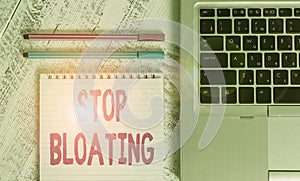Writing note showing Stop Bloating. Business photo showcasing to end the condition where your belly feels full and tight