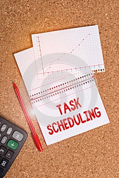 Writing note showing Task Scheduling. Business photo showcasing The assignment of start and end times to a set of tasks Desk