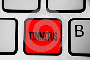 Writing note showing Tinnitus. Business photo showcasing A ringing or music and similar sensation of sound in ears Keyboard red In