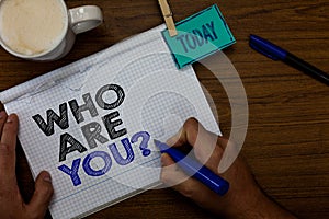 Writing note showing Who Are You question. Business photo showcasing Identify yourself description personal characteristics Hand h