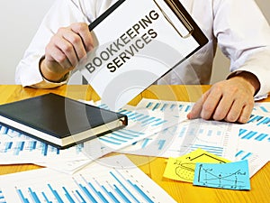 Writing note shows the text bookkeeping services photo