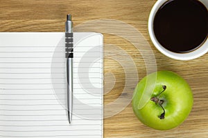 Writing paper and ballpoint-pen on wooden desk photo