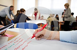 Writing on paper during workshop