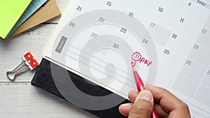 writing pay debt word on calendar