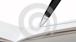 Writing pen in a notebook on a white isolated background.