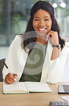 Writing, portrait and business black woman with notebook at her office desk for Human Resources planning, strategy and