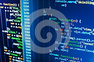 Writing programming code on laptop.