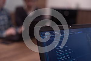 Writing programming code on laptop