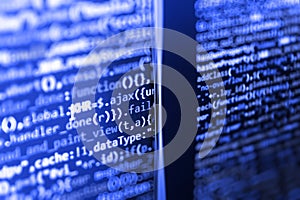 Writing programming code on laptop.