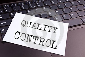 Writing Quality Control text made in the office close-up on laptop computer keyboard. Business concept for Product Improvement or