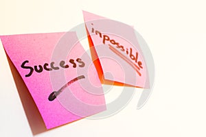 Writing success and posible on post-it. photo