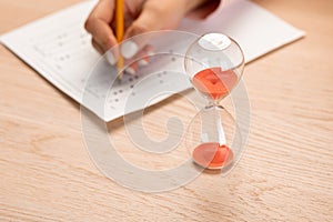 Writing a test in a short time. Students hands to take exams, write an examination room with a pencil holding on the optical form