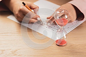 Writing a test in a short time. Students hands to take exams, write an examination room with a pencil holding on the optical form