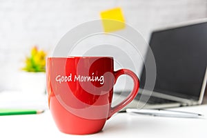 Writing Text Good Morning on the red cup.  Take Care for healthy life office.