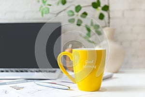 Writing Text Good Morning on the yellow cup. Take Care for healthy life office