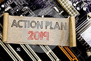 Writing text showing Action Plan 2019. Business concept for Success Strategy Written on sticky note, computer main board backgroun