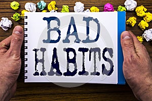 Writing text showing Bad Habits. Business concept for Improvement Break Habitual Hebit written on notepad notebook book on the woo photo