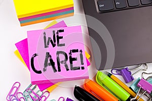 Writing text showing We Care made in the office with surroundings such as laptop, marker, pen. Business concept for Career Assista