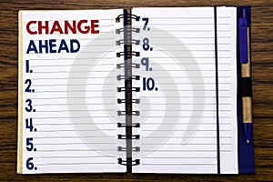 Writing text showing Change Ahead Red Word. Business concept for Future Changes Written on notebook note paper, wooden background