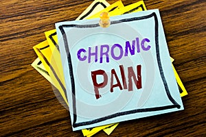 Writing text showing Chronic Pain. Business concept for Feeling Bad ill Care written on sticky note paper on the wooden background