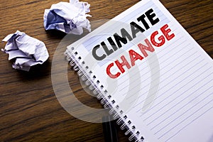 Writing text showing Climate Change. Business concept for Global Planet Warming written on notebook notepad note paper on the wood