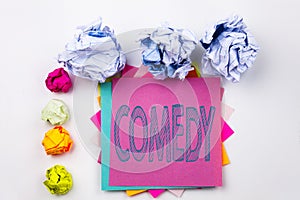 Writing text showing Comedy written on sticky note in office with paper balls. Business concept for Stand Up Comedy Micropho
