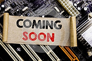 Writing text showing Coming Soon. Business concept for Message Future Written on sticky note, computer main board background.