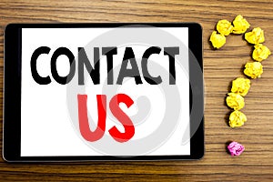 Writing text showing Contact Us. Business concept for Customer Support written on tablet computer on the wooden background with qu