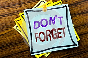 Writing text showing Do Not Forget. Business concept for Don t memory Remider written on sticky note paper on the wooden backgroun photo