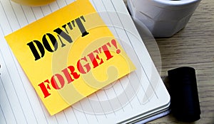 Writing text showing Do Not Forget. Business concept for Reminder Message written sticky note empty paper, Wooden background with