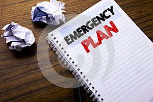 Writing text showing Emergency Plan. Business concept for Disaster Protection written on notebook notepad note paper on the wooden