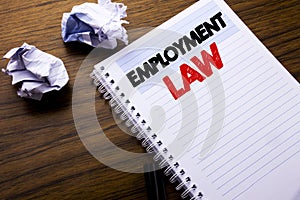 Writing text showing Employment Law. Business concept for Employee Legal Justice written on notebook notepad note paper on the woo photo