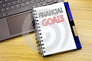 Writing text showing Financial Goals. Business concept for Income Money Plan written on notebook book on the wooden background in