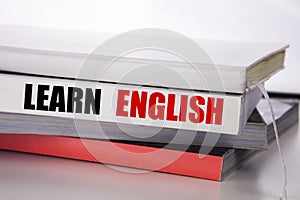 Writing text showing Learn English. Business concept for Language School written on the book on the white background.