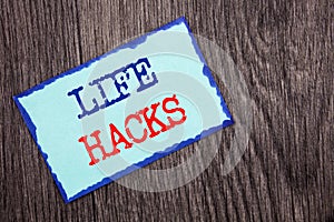 Writing text showing Life Hacks. Business photo showcasing Solution Hacking Hack Trick To Help Efficiency written on Blue Sticky
