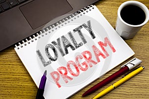 Writing text showing Loyalty Program. Business concept for Marketing Concept written on notebook book on the wooden background in