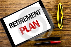 Writing text showing Retirement Plan. Business concept for Pension Finance Written on tablet laptop, wooden background with vacati
